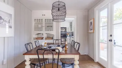 a kitchen and dining room with a table and chairs at Topaz By AvantStay Adorable Cottage Walking Distance to Beach w Large Patio in San Diego