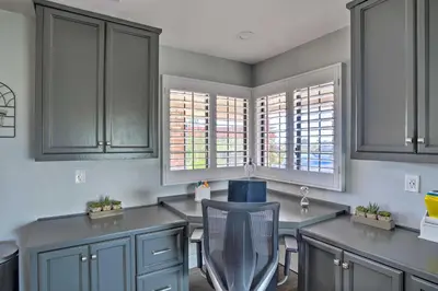 a kitchen with gray cabinets and a chair in it at Hilltop Hideaway in Temecula Wine Country in Sage