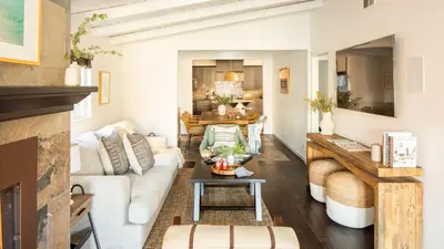 a living room with a white couch and a table at Sand Castle by AvantStay Beach House on Balboa Peninsula w Patio Hot Tub in Newport Beach