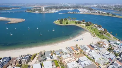 an aerial view of a beach with boats in the water at Mission Point Buyout by AvantStay Two Unit Buyout w Patio Fire Pit Close to Beach 6BDRs in San Diego