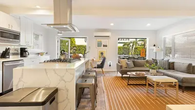 a kitchen and living room with a couch and a table at Mission Point 1 by AvantStay San Diego Beach House w Huge Patio Fire Pit Walk to Beach in San Diego