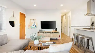 a living room with a couch and a table at Mission Point 1 by AvantStay San Diego Beach House w Huge Patio Fire Pit Walk to Beach in San Diego