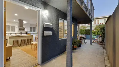 a kitchen and a living room with a patio at Mission Point 1 by AvantStay San Diego Beach House w Huge Patio Fire Pit Walk to Beach in San Diego