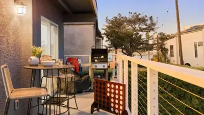 a balcony with a table and a stove at Mission Point 2 by AvantStay Mission Beach Home w Large Balcony Steps to Beach in San Diego