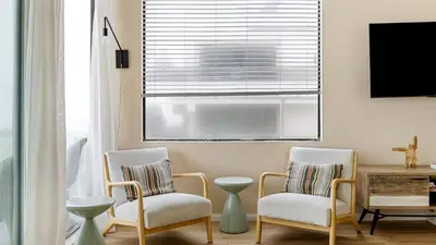 a living room with two chairs and a window at Beachfront Home w Ocean Views • Right on Mission Beach Belmont by AvantStay in San Diego