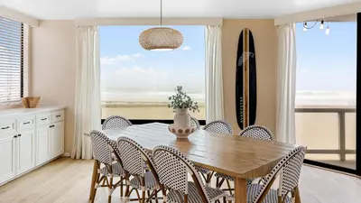 a dining room with a table and chairs with a view of the ocean at Beachfront Home w Ocean Views • Right on Mission Beach Belmont by AvantStay in San Diego