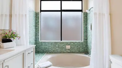 a bathroom with a tub and a window at Beachfront Home w Ocean Views • Right on Mission Beach Belmont by AvantStay in San Diego