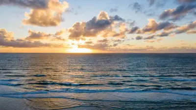 a sunset over the ocean with the sun setting at Beachfront Home w Ocean Views • Right on Mission Beach Belmont by AvantStay in San Diego