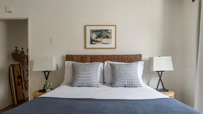 a bedroom with a bed with pillows and two lamps at Bay View II by AvantStay Ocean View Mission Beach Home on the Sand in San Diego