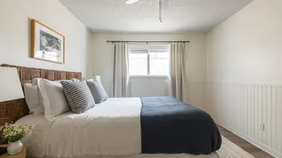 a bedroom with a bed and a window at Bay View II by AvantStay Ocean View Mission Beach Home on the Sand in San Diego