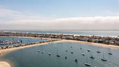 an aerial view of a beach with boats in the water at Bay View II by AvantStay Ocean View Mission Beach Home on the Sand in San Diego