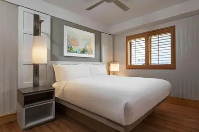 a bedroom with a large white bed and a window at Pier South Resort, Autograph Collection in Imperial Beach