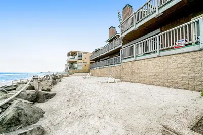a building on the beach next to the ocean at Whitewater Village Charm in Oceanside