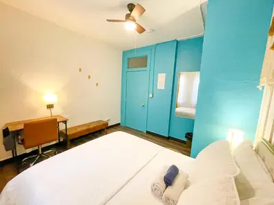 a bedroom with a large bed and a blue wall at ITH San Diego Mission Beach Backpacker Hostel in San Diego