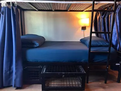 a bedroom with a bunk bed with a blue bed at ITH San Diego Mission Beach Backpacker Hostel in San Diego
