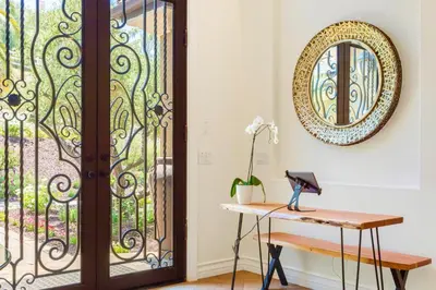 a room with a door and a desk with a mirror at Gaia Inn & Spa- Adult Only- Temecula Wine Country in Temecula