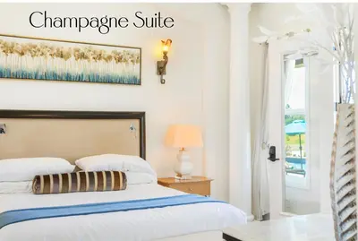 a bedroom with a bed and a sign that reads champagne suite at Gaia Inn & Spa- Adult Only- Temecula Wine Country in Temecula