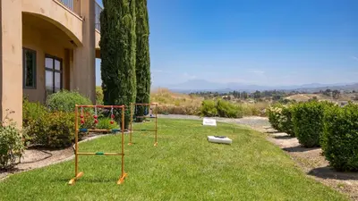 a garden with two golf carts in the grass at Palazzo Del Sol By AvantStay Breathtaking Home w Mountain Views Hot Tub in Temecula