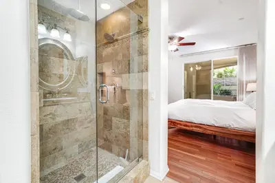 a bathroom with a shower and a bed in a room at Ocean Pointe Getaway - 30-Night Minimum in Carlsbad