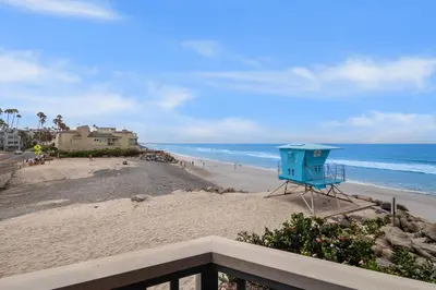 a view of a beach with a blue lifeguard tower at Whitewater Village Retreat B in Oceanside