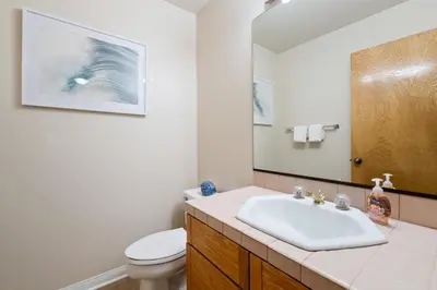 a bathroom with a sink and a toilet and a mirror at Whitewater Village Retreat B in Oceanside