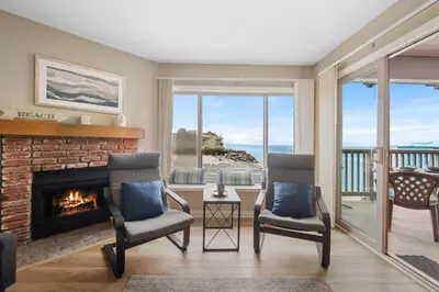 a living room with two chairs and a fireplace at Whitewater Village Retreat B in Oceanside