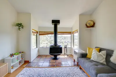 a living room with a couch and a wood stove at La Mesa Townhome 15 Mi to San Diego! in La Mesa
