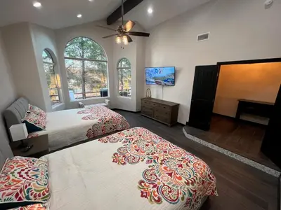 a bedroom with two beds and a flat screen tv at Winery Getaway with Spa and Amazing Hilltop View in Temecula