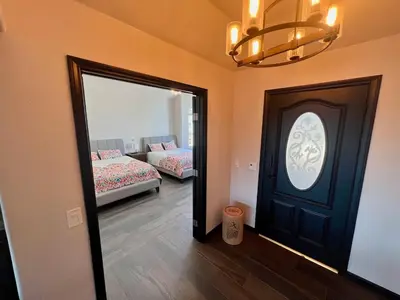 a room with a door and a couch and a mirror at Winery Getaway with Spa and Amazing Hilltop View in Temecula