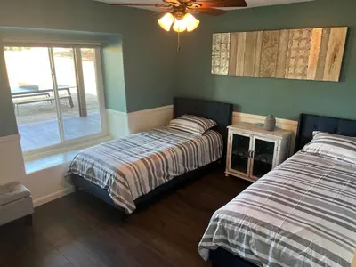 two beds in a room with green walls and a window at Winery Getaway with Spa and Amazing Hilltop View in Temecula