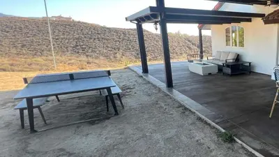 a patio with a picnic table and a couch at Winery Getaway with Spa and Amazing Hilltop View in Temecula