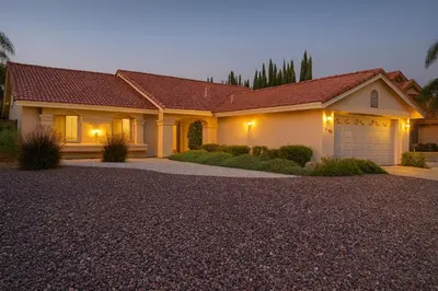 a large house with a garage at night at Starlight Western Room in Hemet