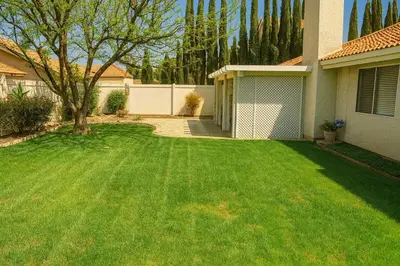 a yard with a green lawn in front of a house at Sundance Retreat in Hemet