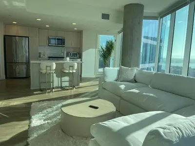 a living room with a couch and a table at Luxury Designer Suite with Rooftop Pool, Gym in San Diego
