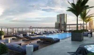 a rooftop lounge with couches and a swimming pool at Luxury Designer Suite with Rooftop Pool, Gym in San Diego