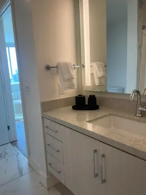 a bathroom with a sink and a mirror at Luxury Designer Suite with Rooftop Pool, Gym in San Diego