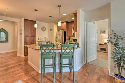 a kitchen with two green bar stools at a counter at Breezy Oceanside Condo Less Than half Mi to Beach! in Oceanside