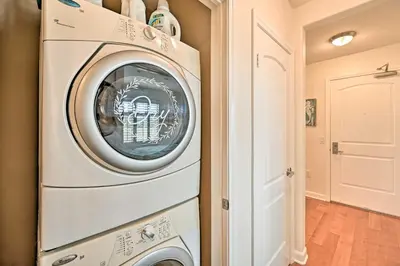 a washer and dryer in a laundry room at Breezy Oceanside Condo Less Than half Mi to Beach! in Oceanside