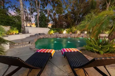 two chairs and a swimming pool in a backyard at Mi Casa es Su Casa! (My Home is Your Home!) in Vista