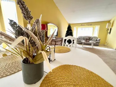 a living room with a potted plant on a table at Rosewood Retreat in Hemet