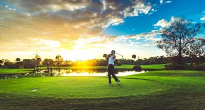 a man swinging a golf club on a golf course at Meadow Harvest Suite with TV and private bathroom in Hemet