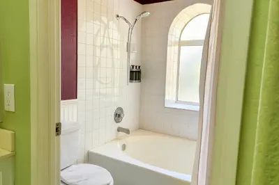 a bathroom with a tub and a toilet and a sink at Meadow Harvest Suite with TV and private bathroom in Hemet