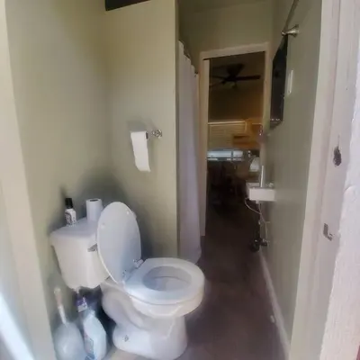 a bathroom with a white toilet in a room at Cozy, Cheerful & Charming Cabin - Historic Julian in Julian