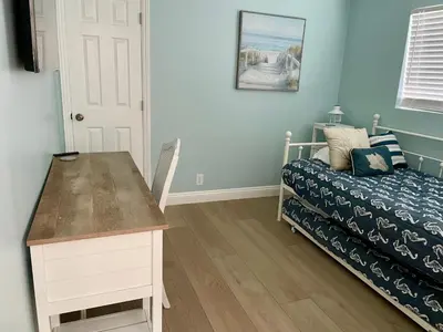 a bedroom with a bed and a desk next to a bed at Blue Whale Inn San Clemente Jewel Unit D in San Clemente