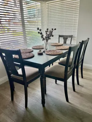 a dining room table with chairs and a vase with flowers at Blue Whale Inn Pet and Kid Friendly Unit C in San Clemente