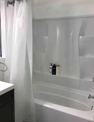 a bathroom with a white tub and a white shower curtain at Studio Free Parking Walk to Convention in San Diego