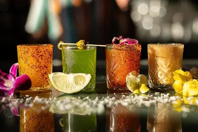a group of four glasses filled with different colored drinks at Studio Free Parking Walk to Convention in San Diego
