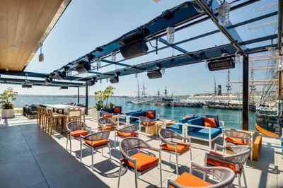 a deck on a ship with chairs and tables at 2BR Walk to Convention Center Free Parking in San Diego