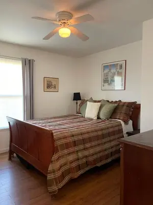 a bedroom with a bed with a ceiling fan at House on Organic Farm in Escondido