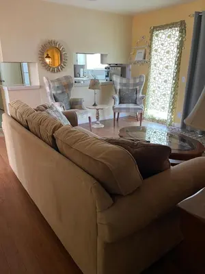 a living room with a brown couch and chairs at House on Organic Farm in Escondido